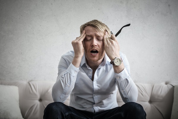 A Man Being Stress On His Work