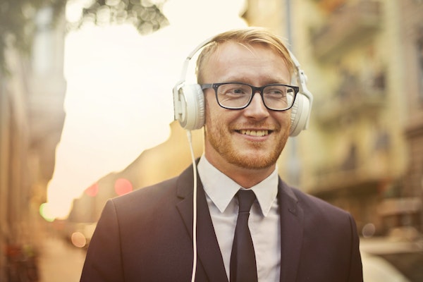 A Man Smiling While Listening To Music