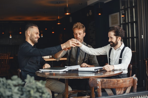 A Group Of Guys Celebrating Their Accomplishments