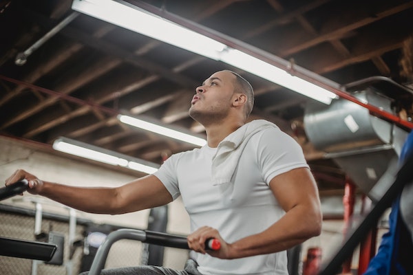 A Man Doing Cardio Using A Stationary Bike