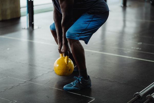 A Man Doing Kettlebell Swings