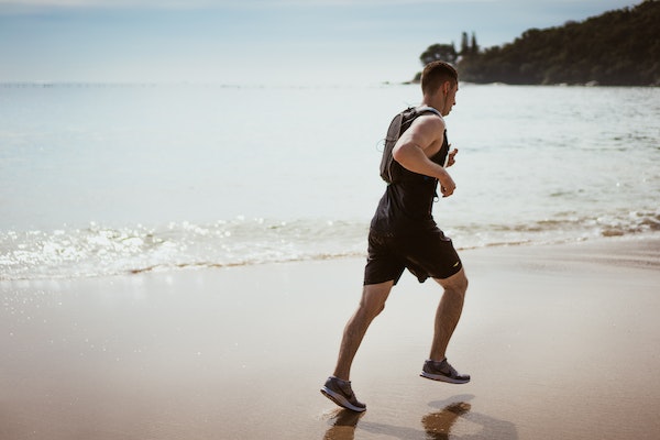 A Man Jogging On A Beach