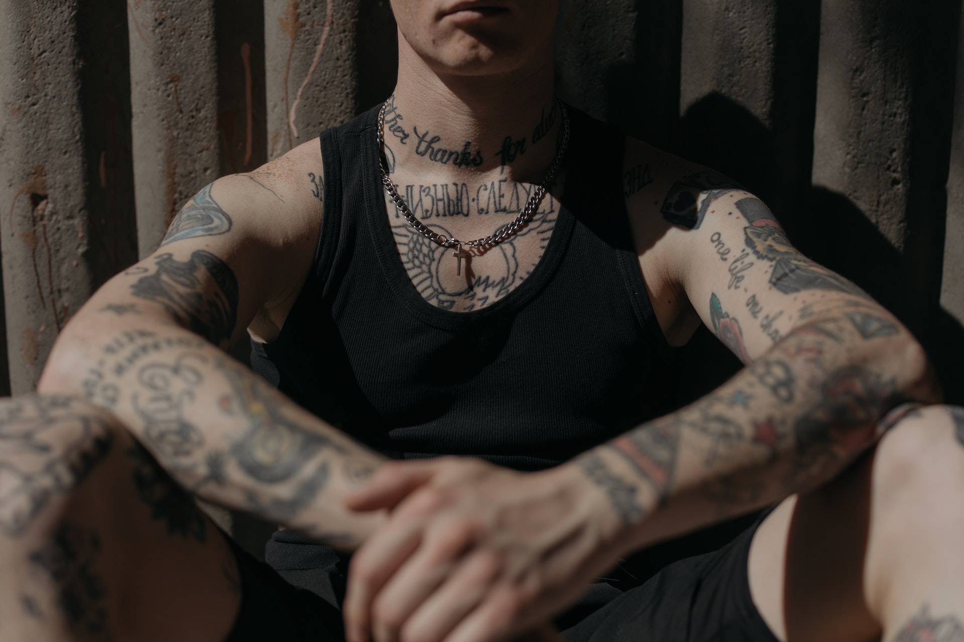 A guy in a black shirt with tattoos