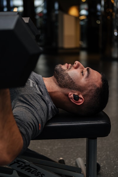 A Man Doing Chess Press With Workout Bench