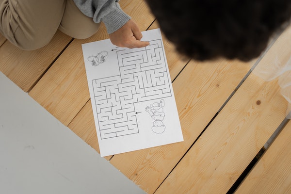 A Man Trying To Solve A Maze Puzzle