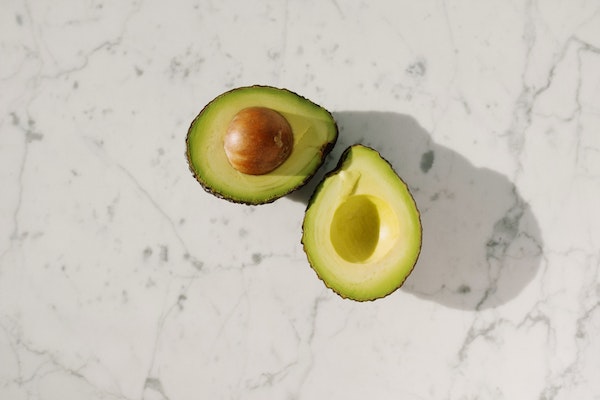 A Sliced Avocado With Seed On