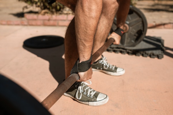 A Guy Using Straps For Lifting
