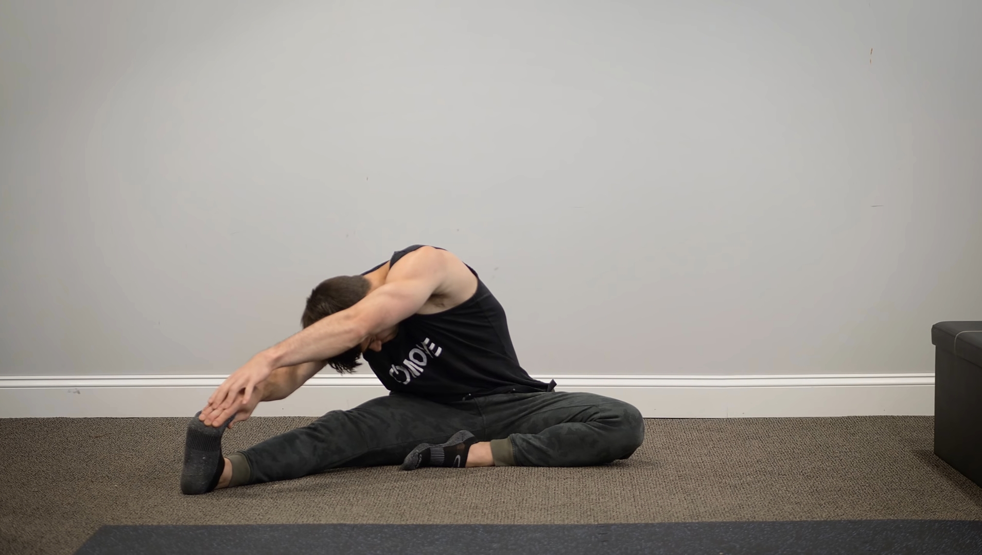 A Man Doing Head To Knee Stretch 