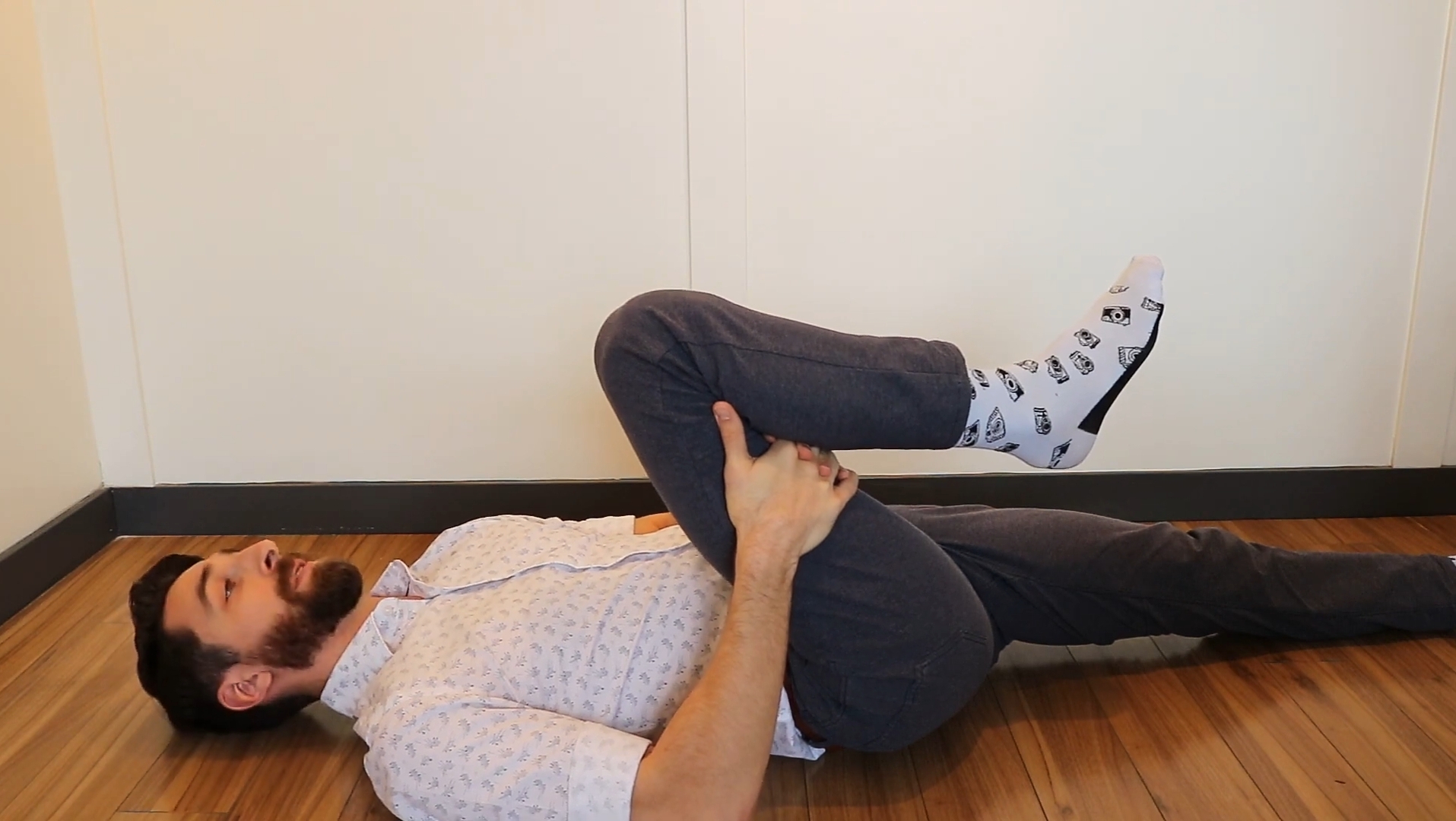 A Man Doing Knee To Chest Stretch 