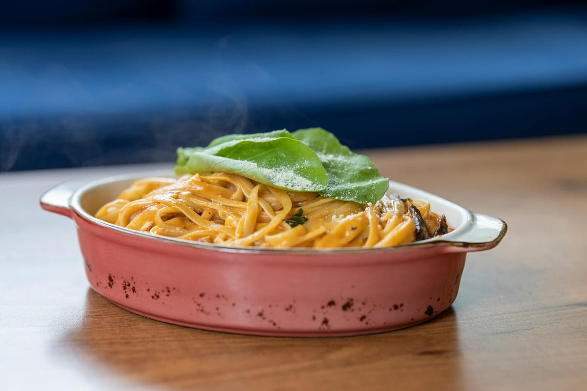 pasta with basil leaves on top