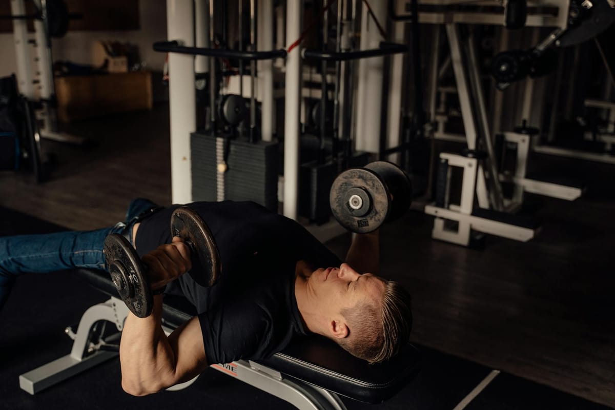 a man doing a dumbbell chest press