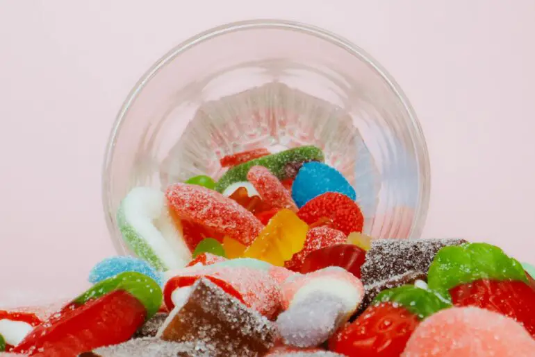 assorted delicious candies in clear plastic bowl